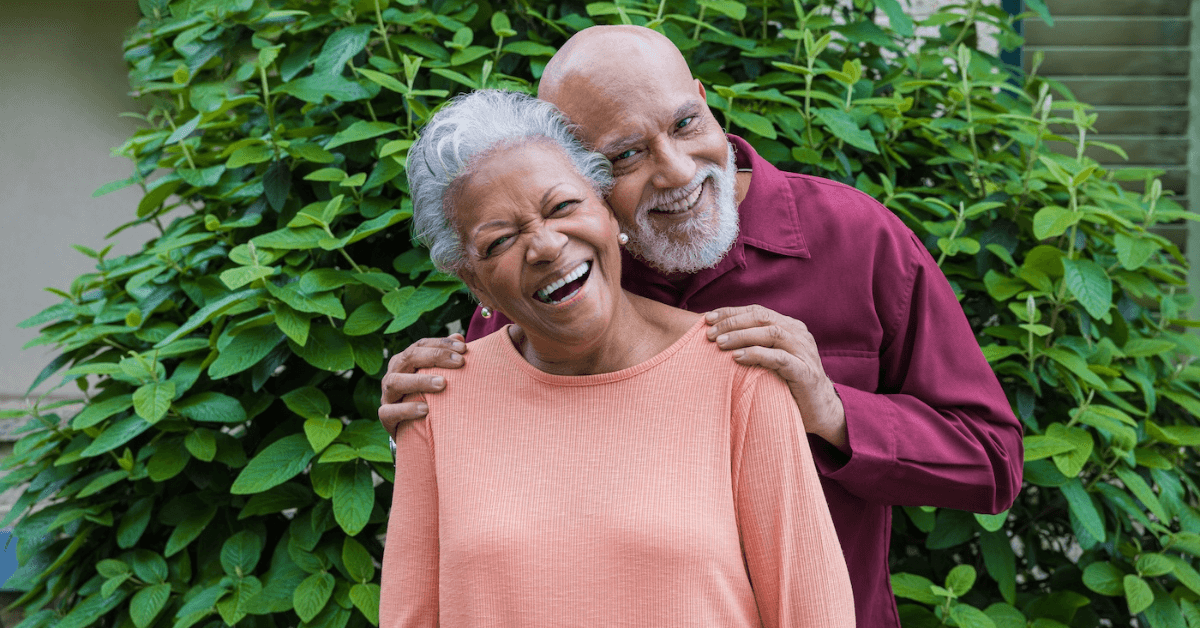 two residents smiling outside