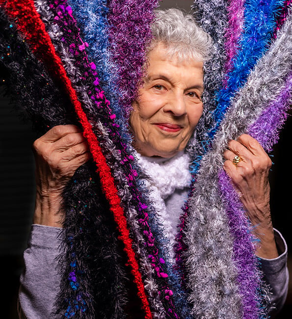 Senior woman surrounded by colorful material