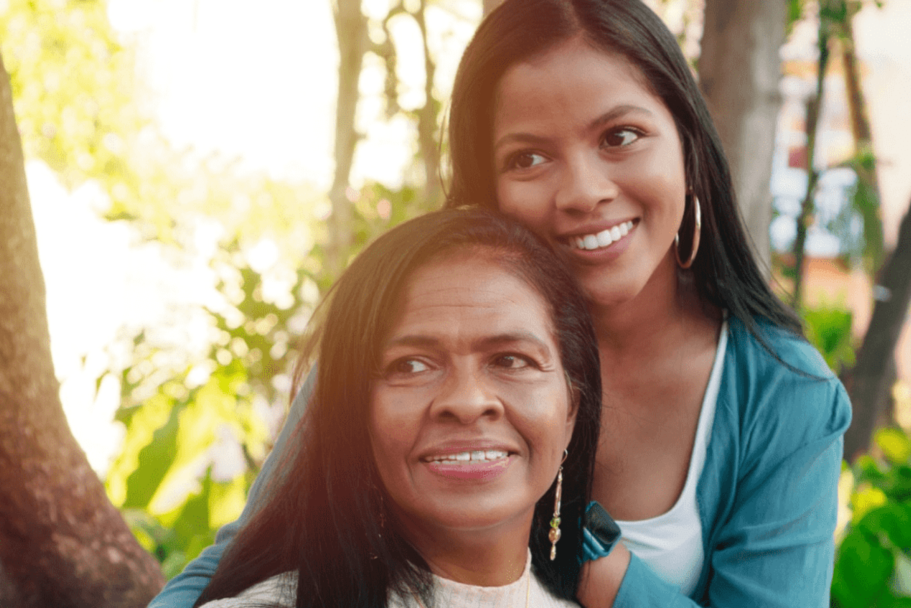 smiling mother and daughter outside